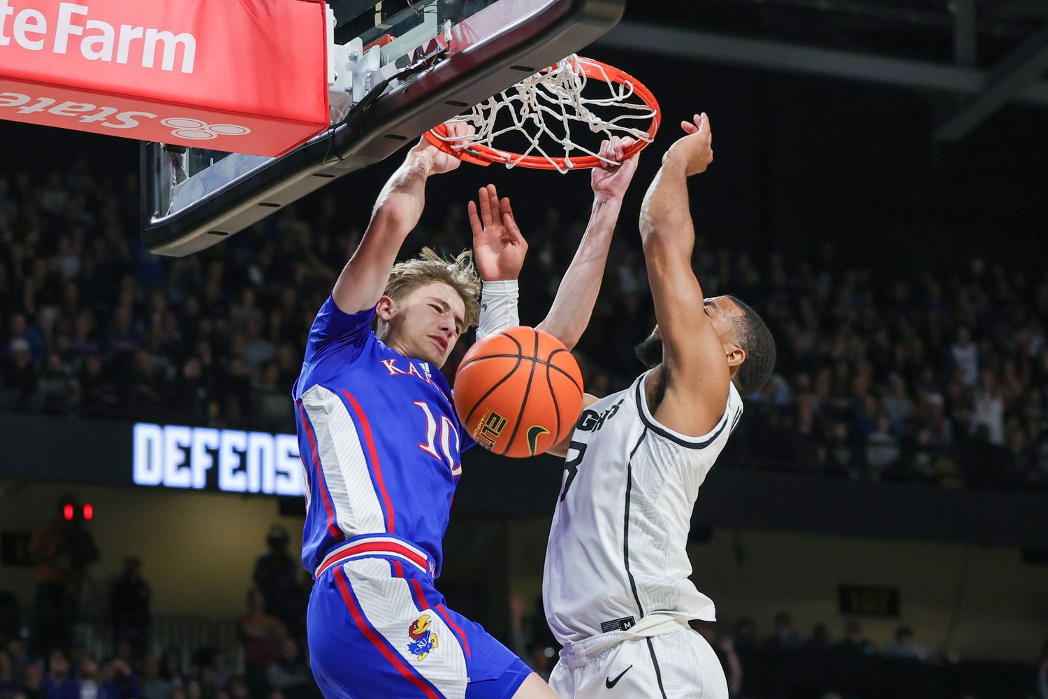 Jan 10, 2024; Orlando, Florida, USA; Kansas Jayhawks guard Johnny Furphy (10) dunks against UCF Knights guard Darius Johnson (3) during the first period at Addition Financial Arena.